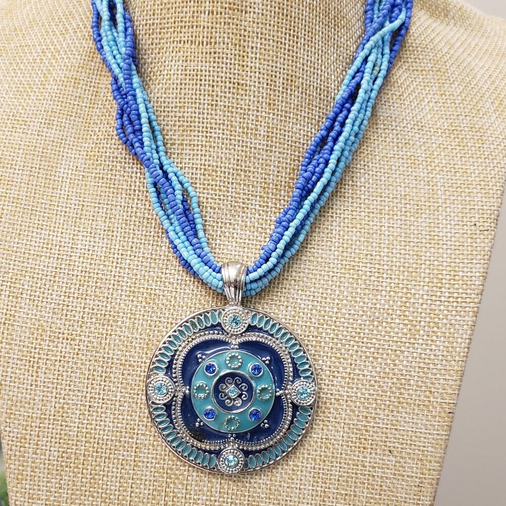 Turquoise, blue silver multi strand see bead ,heavy medallion pendant necklace